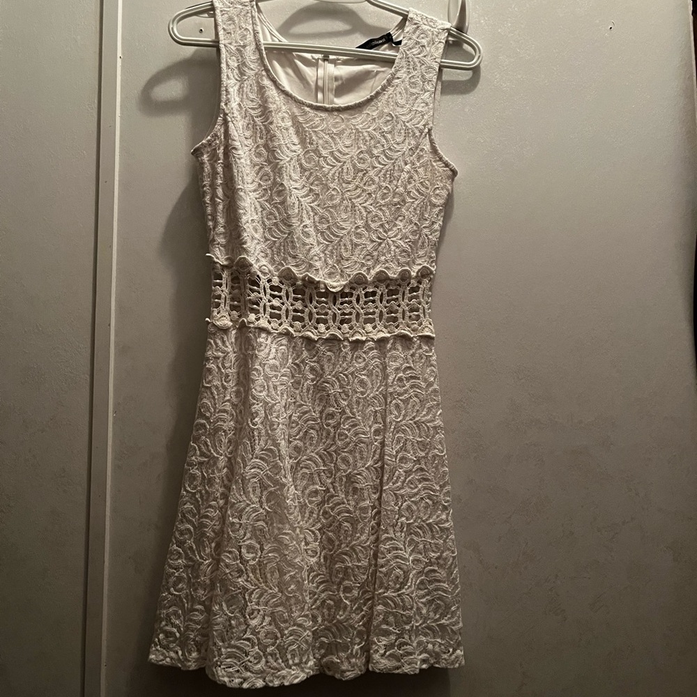 White lace dress with see through panels around stomach.